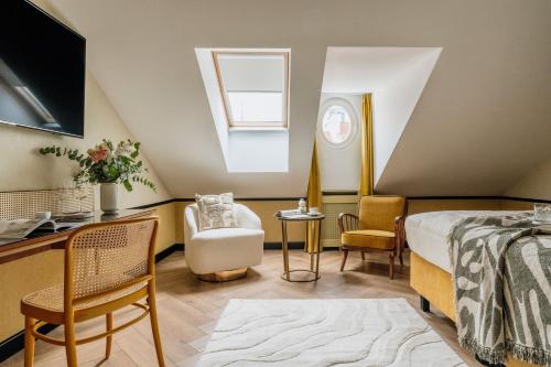 a bedroom with a bed and a desk and a window at Colette - LoftAffair Collection in Warsaw