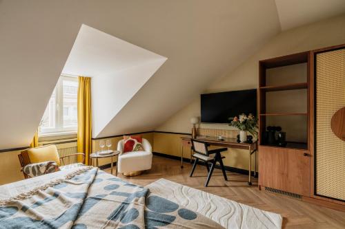 a bedroom with a bed and a desk and a tv at Colette - LoftAffair Collection in Warsaw