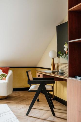 a room with a desk with a chair and a table at Colette - LoftAffair Collection in Warsaw
