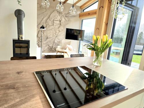 a kitchen with a counter with a vase of flowers at Hunsrücker Tiny Ferien L in Hottenbach
