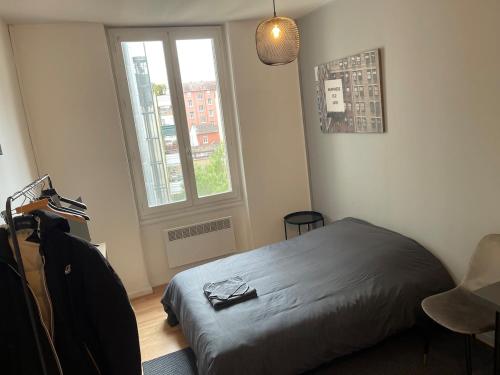 - une chambre avec un lit en face d'une fenêtre dans l'établissement Studio Hôtel Villeurbanne Centre, à Villeurbanne
