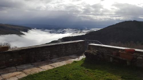 a view of a mountain with clouds in the valley at Villa Letizia in Oprtalj