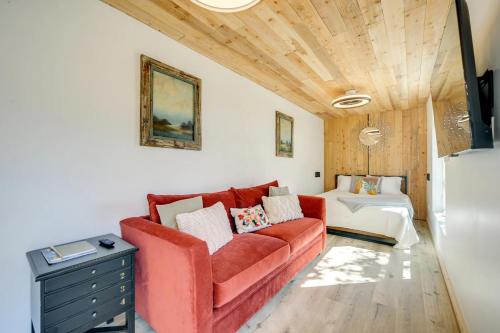 a living room with a red couch and a table at Modern Hill Country Container in Spicewood