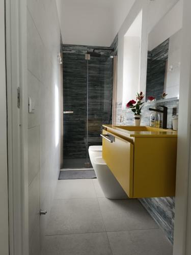 a bathroom with a sink and a toilet and a shower at Ruffoli-Home a 300 m dal mare in Rosignano Solvay