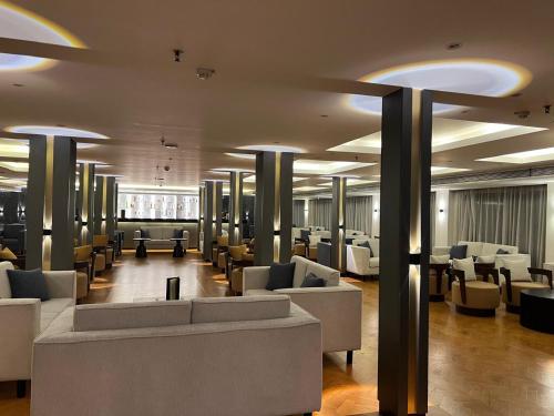 a lobby with couches and chairs in a building at Nile Cruise 5 Stars From Luxor And Aswan 3&4 Nights in Aḑ Ḑab‘īyah