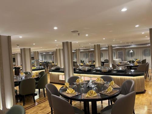 a restaurant with tables and chairs and a bar at Nile Cruise 5 Stars From Luxor And Aswan 3&4 Nights in Aḑ Ḑab‘īyah