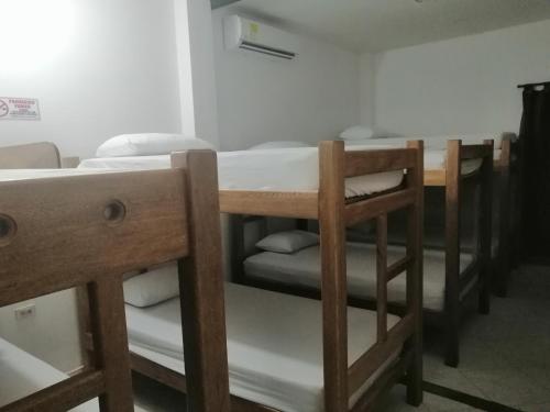 a group of bunk beds in a room at Hostal Arrecifes in Necoclí