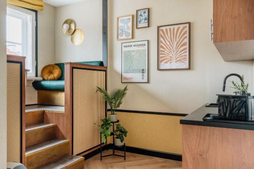 a kitchen with a sink and stairs in a room at Colette - LoftAffair Collection in Warsaw