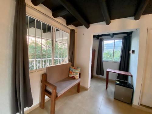 a living room with a chair and a window at Vito Hotel Boutique Taganga in Taganga