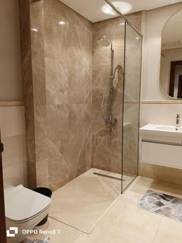 a bathroom with a shower and a toilet and a sink at luxury apartment three bedrooms three bathrooms in 6th Of October