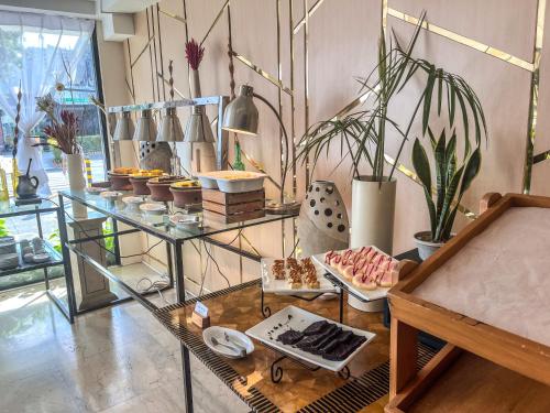 a room with a glass shelf with dishes and plants at Cebu Grand Hotel in Cebu City