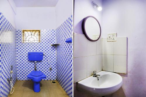 a bathroom with a blue toilet and a sink at Hotel O Mahamaya Holiday Inn in Goa