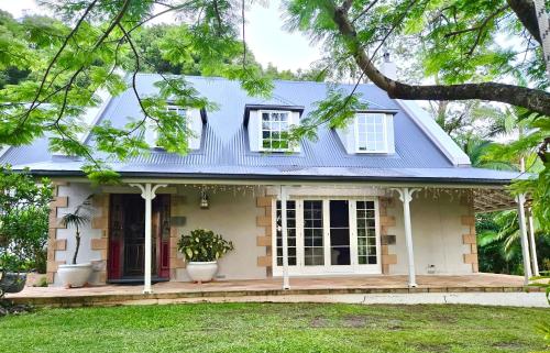 a house with a blue roof at Grande Eden Estate - Main House in Bilambil