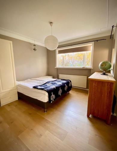 una camera da letto con un letto e una finestra di Oskars Cabin a Reykjavik