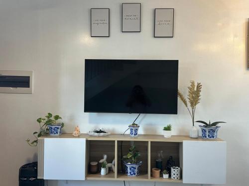 a flat screen tv sitting on top of a white entertainment center at Casa Bella in Baclayon