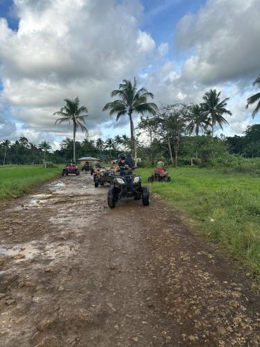 a group of people riding atvs on a dirt road at Casa Bella in Baclayon