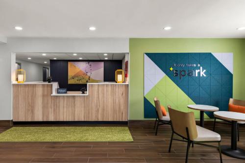 a lobby with a waiting area with tables and chairs at Spark by Hilton Norfolk in Norfolk