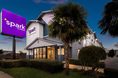 a palm tree in front of a building at Spark by Hilton Norfolk in Norfolk