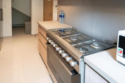a kitchen with a stove top oven in a kitchen at White Villa By the Sea in Fujairah