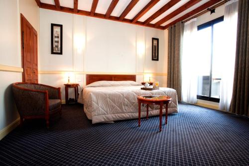 A bed or beds in a room at Hôtel Losset