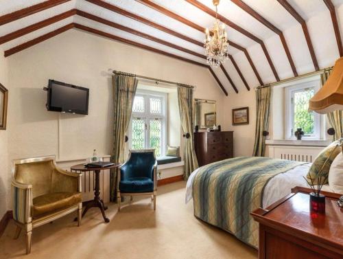 a bedroom with a bed and a desk and a tv at Moyvannan Castle on 7 Acres in Roscommon