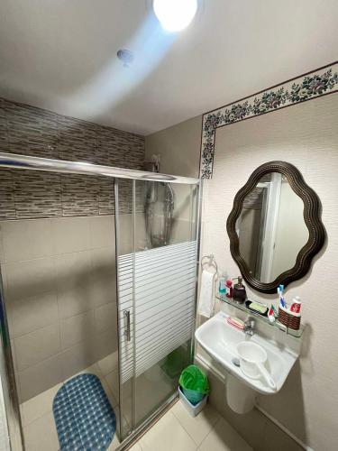 a bathroom with a shower and a sink and a mirror at Sunvida Tower 2819-2818 in Cebu City