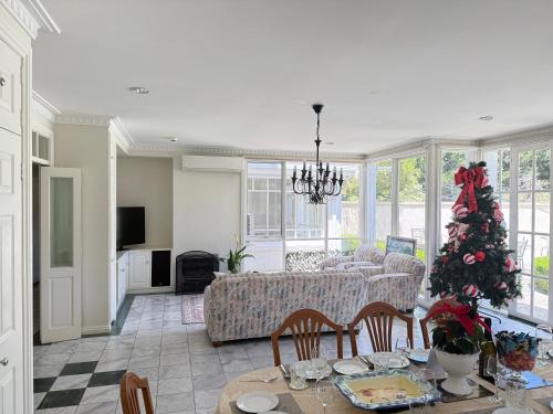 a living room with a christmas tree and a couch at Stunning White House Luxury Retreat In Templestowe in Templestowe