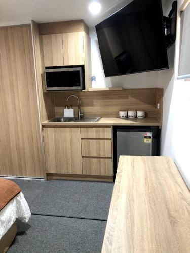 a small kitchen with a sink and a microwave at Studio 885 in North Shields