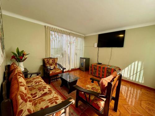 a living room with a couch and a table at Tika house in Cusco