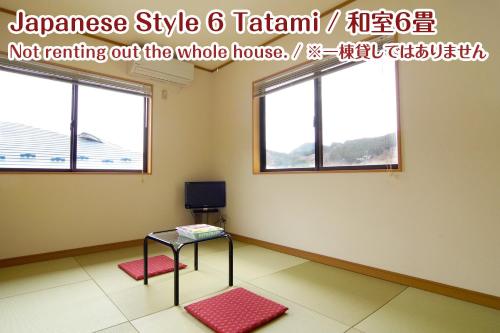 a room with a table and two windows at NIKKO stay house ARAI - Vacation STAY 14988v in Nikko