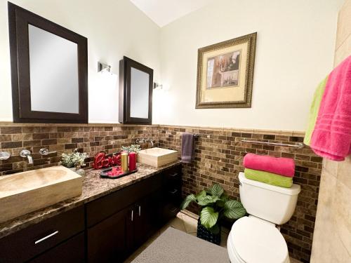 a bathroom with a sink and a toilet and a mirror at Art Downtown Fulton Market Entire 3 bedroom Home Sleep10 Private Garage Roof EV Tesla in Chicago