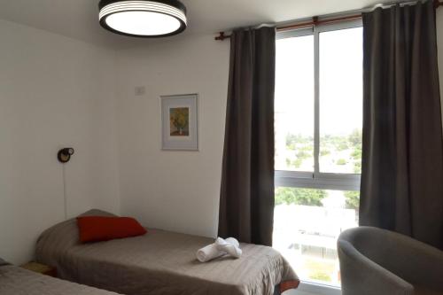 a bedroom with two beds and a window at Departamento Buena Vista in Leones