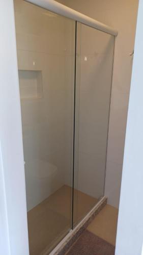 a glass shower door in a room with at ACONCHEGO DA SERRA in Teresópolis