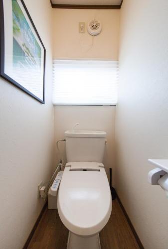 a bathroom with a white toilet with a window at 10 min walk to the beach Kujukuri house for 14 ppl in Hasunuma