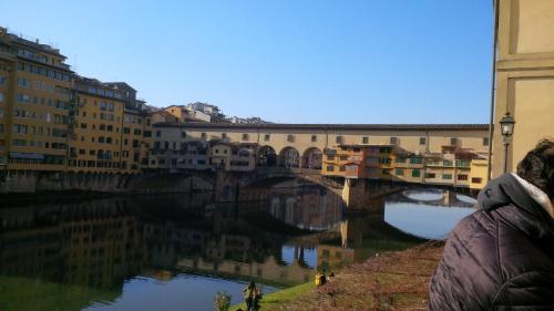 a bridge over a river in a city at Albergo Ristorante La Greppia in Montedivalli Chiesa