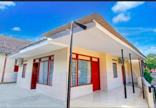 a small house with a red door at Khazanah Room Syariah by Secoms in Demangan