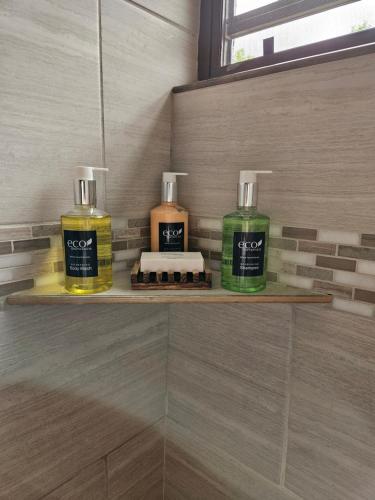 two bottles of soap on a shelf in a bathroom at Casa Aramana in Vieques