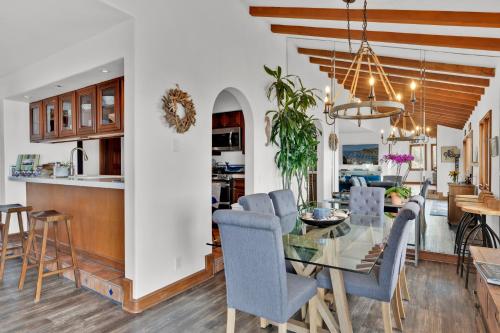 a dining room and kitchen with a glass table and chairs at Gorgeous Oceanfront Villa With Panoramic Views in Avalon