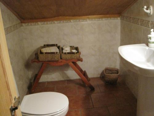 a bathroom with a toilet and a sink at Casa de piedra en el Valle de Lozoya in Canencia