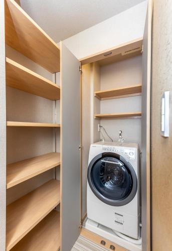 a washer and dryer in a closet at Kyoto Takatsuji Rose Heights in Kyoto