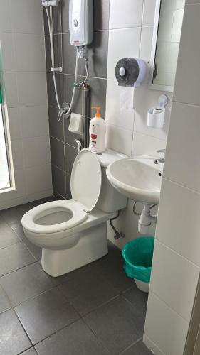 a bathroom with a toilet and a sink at Sweet Homestay 3RM @ Penthouse Apartment in Brinchang in Brinchang