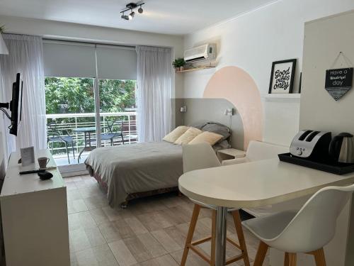 a bedroom with a bed and a table and a dining room at Monoambiente lujoso en Cañitas! in Buenos Aires