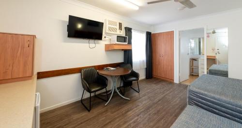 a small room with a table and a bed at Riviera on Ruthven in Toowoomba