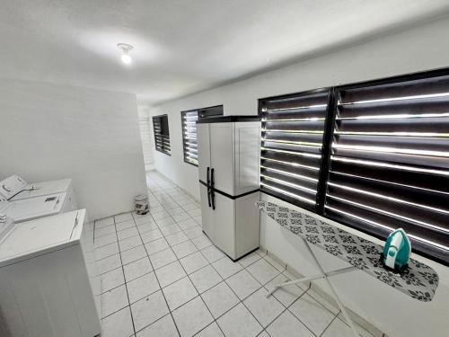 a kitchen with a bench in the middle of a room at Vacation Rental Ceiba PR B16 in Ceiba