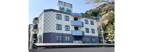 a building with a sign on top of it at ホテルヴィラジュリア ナガラ - 大人専用 in Gifu