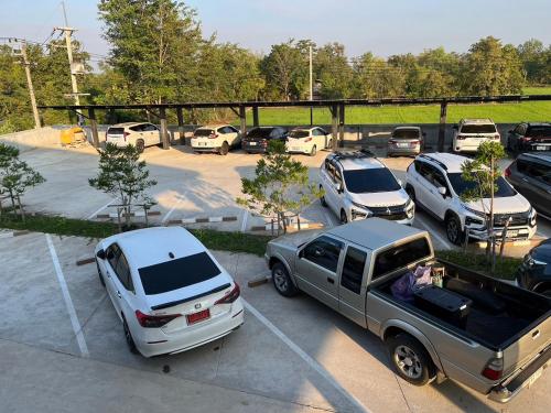 a group of parked cars in a parking lot at BuGaan Sukhothai Village in Sukhothai