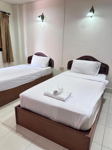 Ένα ή περισσότερα κρεβάτια σε δωμάτιο στο Phurafah Place Hotel โรงแรมภูระฟ้า เพลส