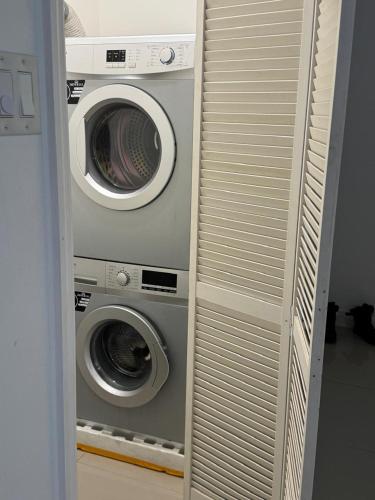 two washing machines sitting next to each other at Harloes Suites - Kingston - Free Parking and Pool in Kingston