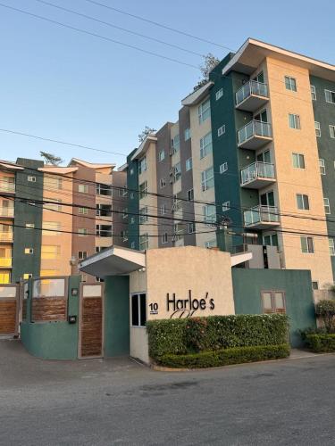 a building with a sign that reads harrods at Harloes Suites - Kingston - Free Parking and Pool in Kingston