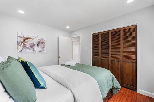 a bedroom with a bed and a wooden closet at 1580 - SFO Spacious & Beautiful 3BR house in Milbrae in Millbrae